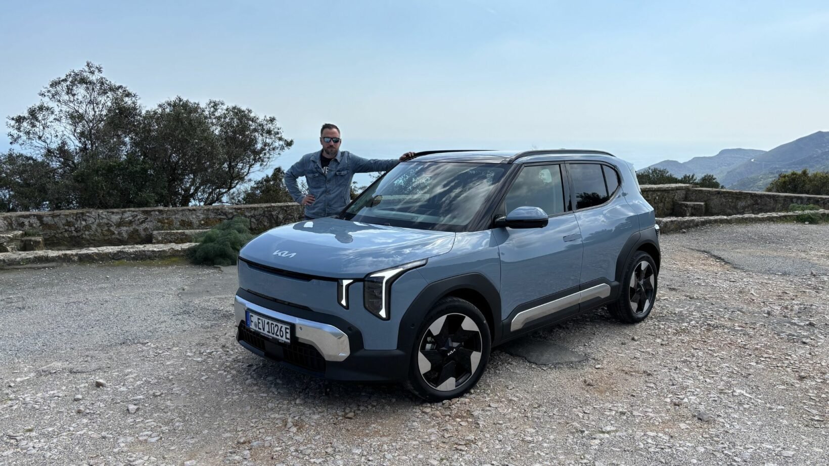Victor Diakov devant la Kia EV2 pour illustrer ses dimensions