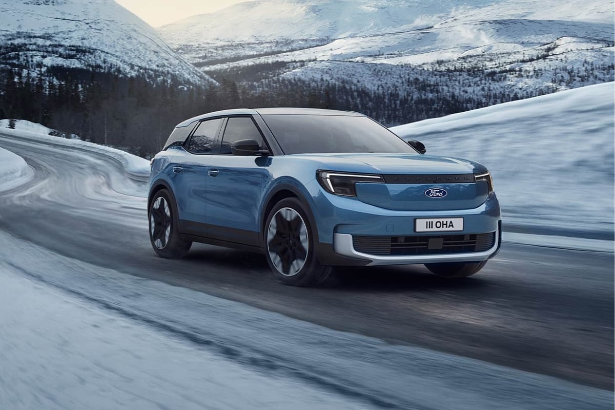 Le Ford Explorer électrique bleu roulant dans la neige, illustrant l'importance de l'autonomie et de la motricité en hiver pour un guide d'achat.