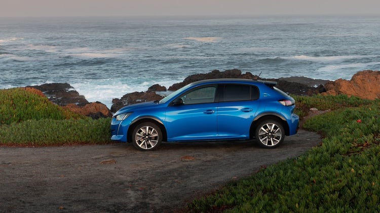 Profil de la Peugeot 208 électrique première génération stationnée près de l’océan