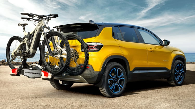Jeep Avenger électrique jaune avec porte-vélos arrière et vélos électriques fixé sur attelage