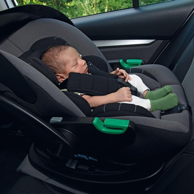 Nouveau-né endormi installé dos à la route dans une coque Foppapedretti Disk Infant i-Size