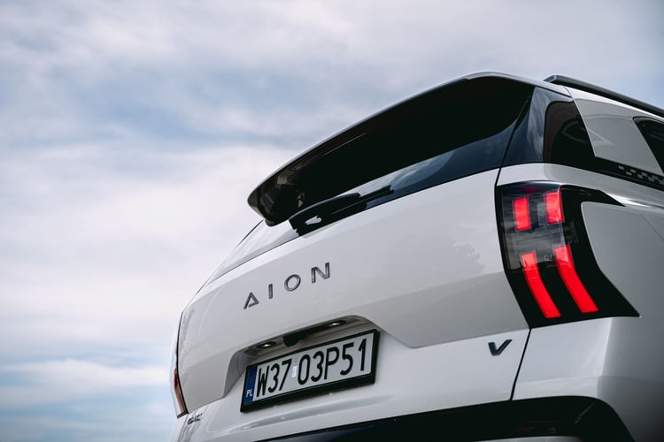 Détail de la poupe du GAC Aion V blanc : lettrage AION, badge V et feu arrière à barres rouges